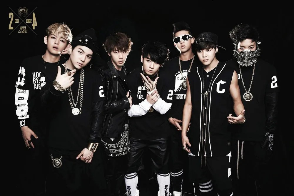 BTS debut era group photo with members RM, Jin, Suga, j-hope, Jimin, V, and Jungkook in 2013 hip-hop outfits
