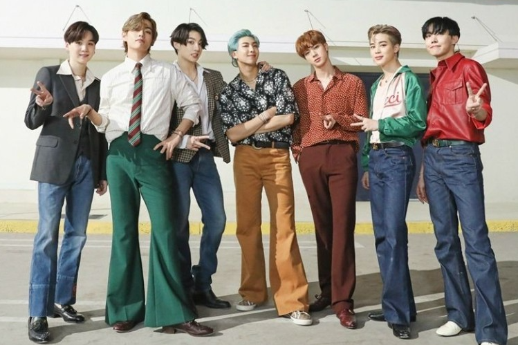 BTS members in 70s retro disco fashion posing outdoors for Dynamite concept photo
