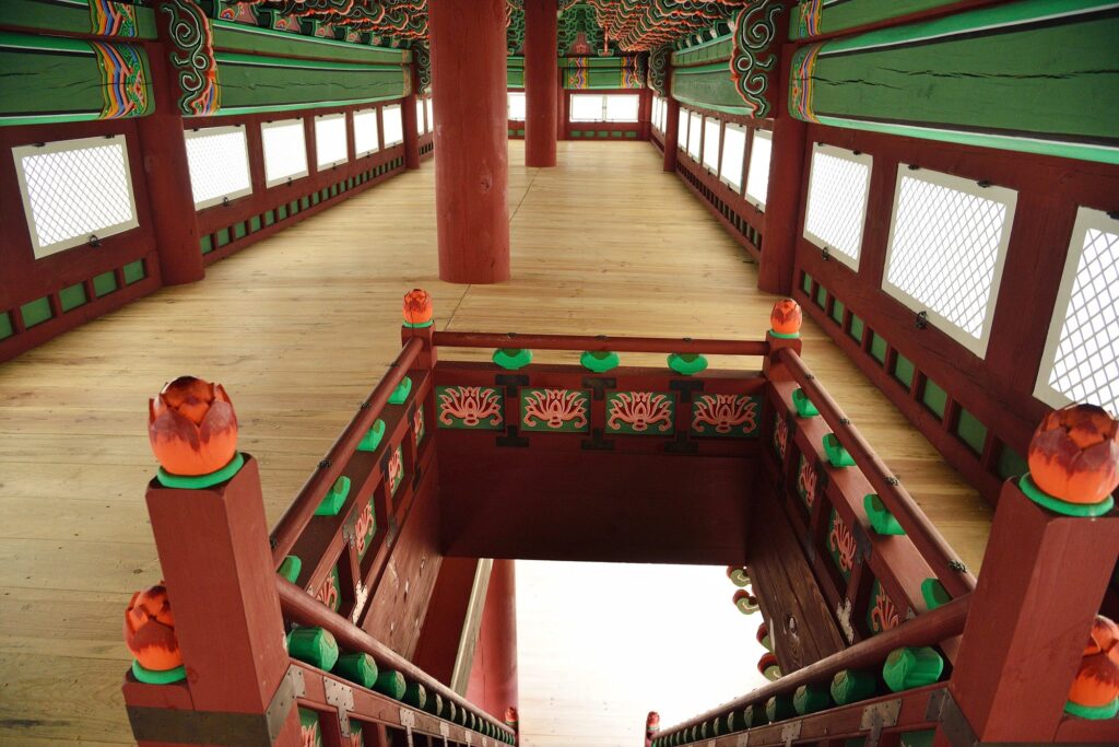 The interior of the Gwanghwamun Gate's second-story wooden pavilion, showing the intricate timber frames and traditional flooring.